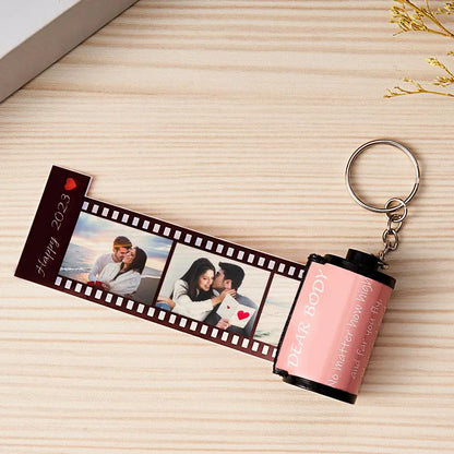 Personalized MadeMine photo film roll keychain with custom image, displayed in a gift box, showcasing a unique keepsake accessory.