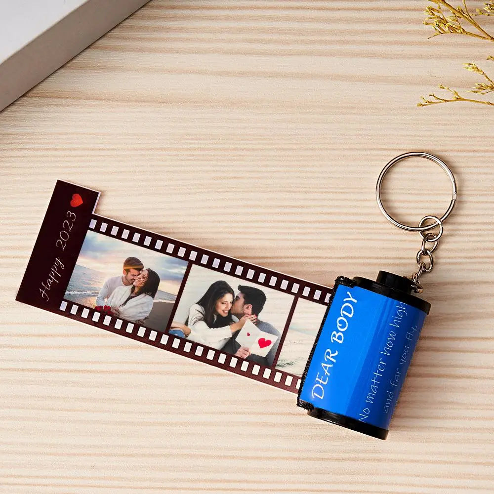 Personalized MadeMine photo film roll keychain with custom photo, shown with gift box, durable metal keychain accessory.