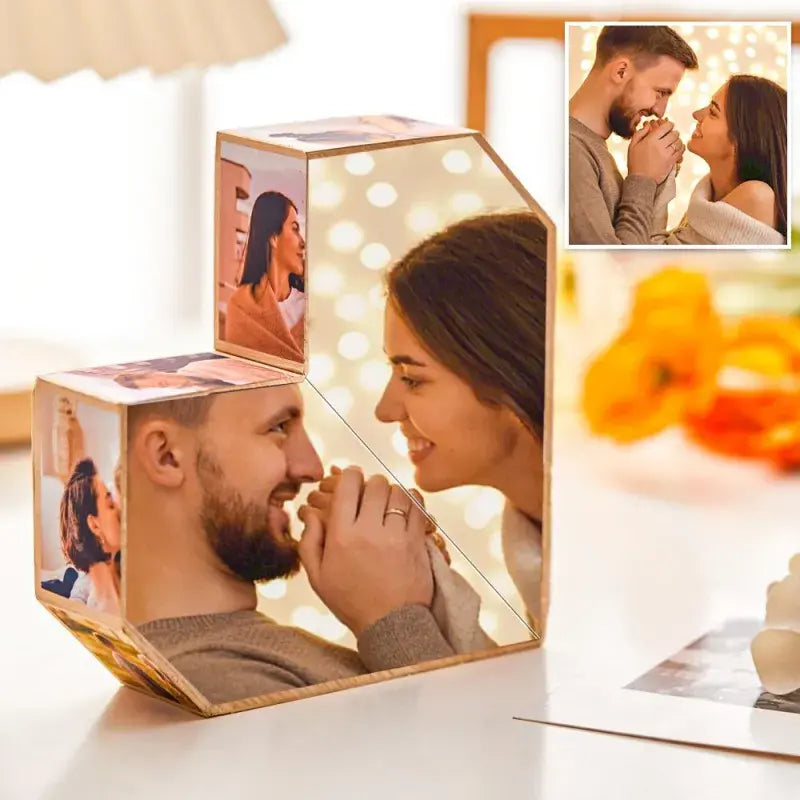 Personalized MadeMine photo cube with wooden base, showcasing multiple custom photos in an infinity folding design for special gifts.