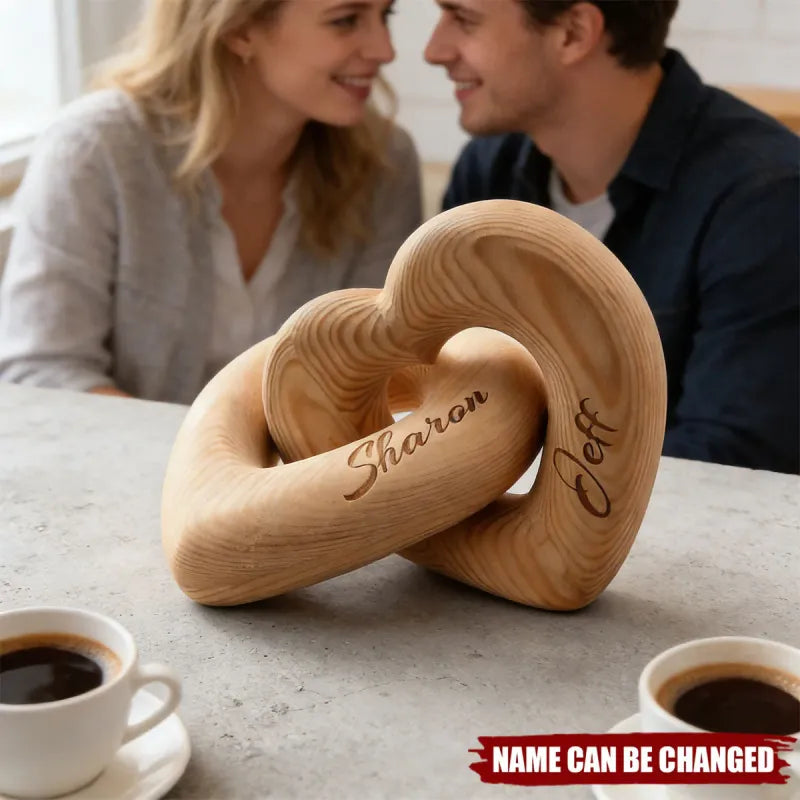 Personalized infinity heart sculpture by MadeMine featuring a romantic couple, showcasing a sleek metal design with intertwined hearts.