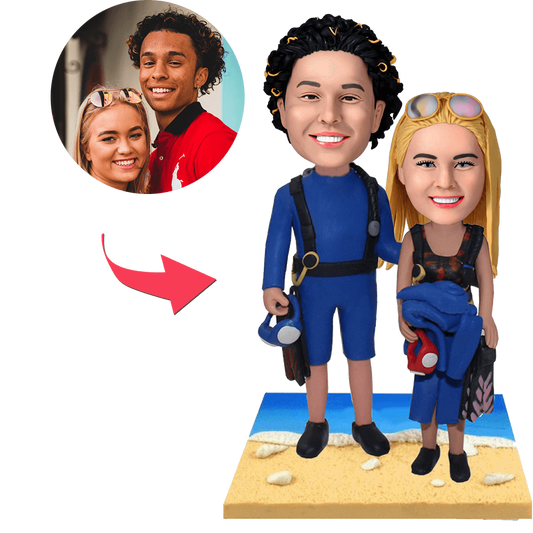 MadeMine wetsuit beach couple bobblehead with engraved text, featuring detailed figures in beach attire and personalized customization.