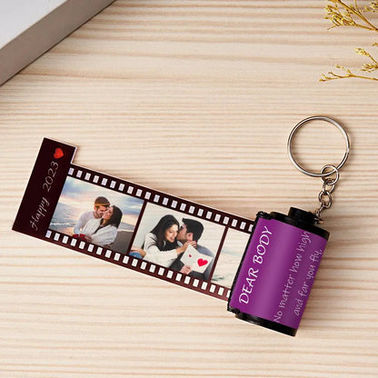 Personalized MadeMine photo film roll keychain with custom photo, attached to a gift box for a unique keepsake.